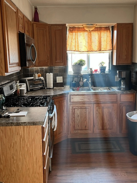 Modern kitchen interior with granite countertops and stainless steel appliances in new apartments in Kansas City KS.